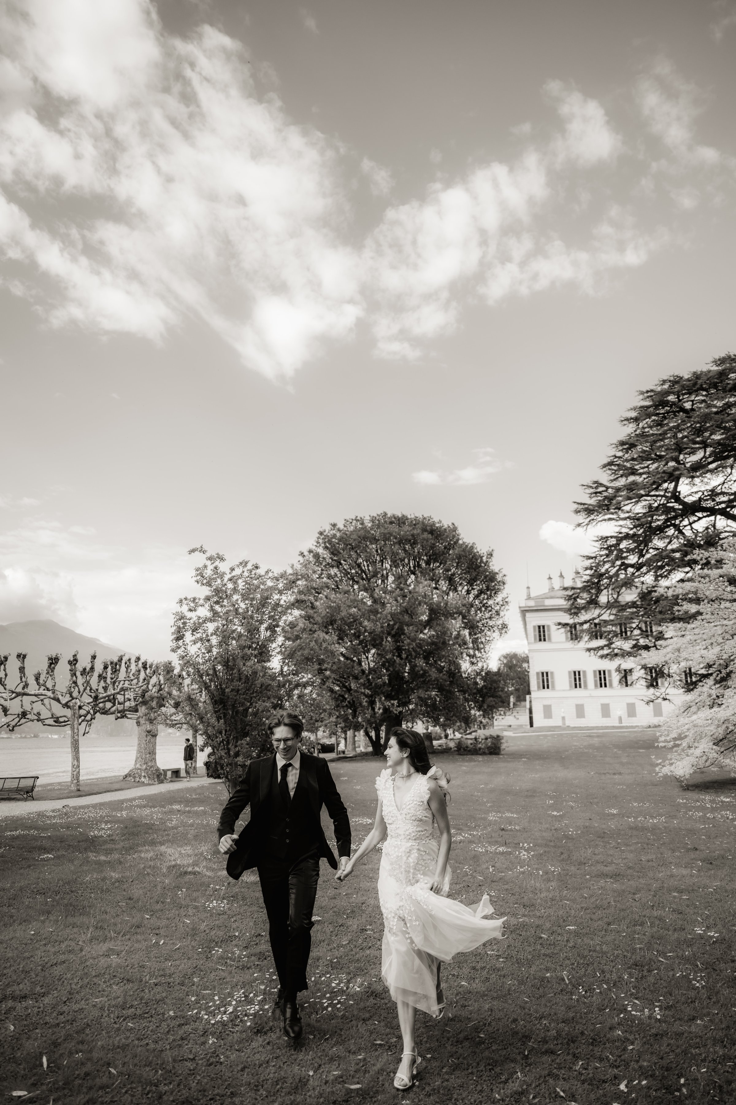 A couple walks beneath a dramatic sky — destination wedding by Aly Zamora